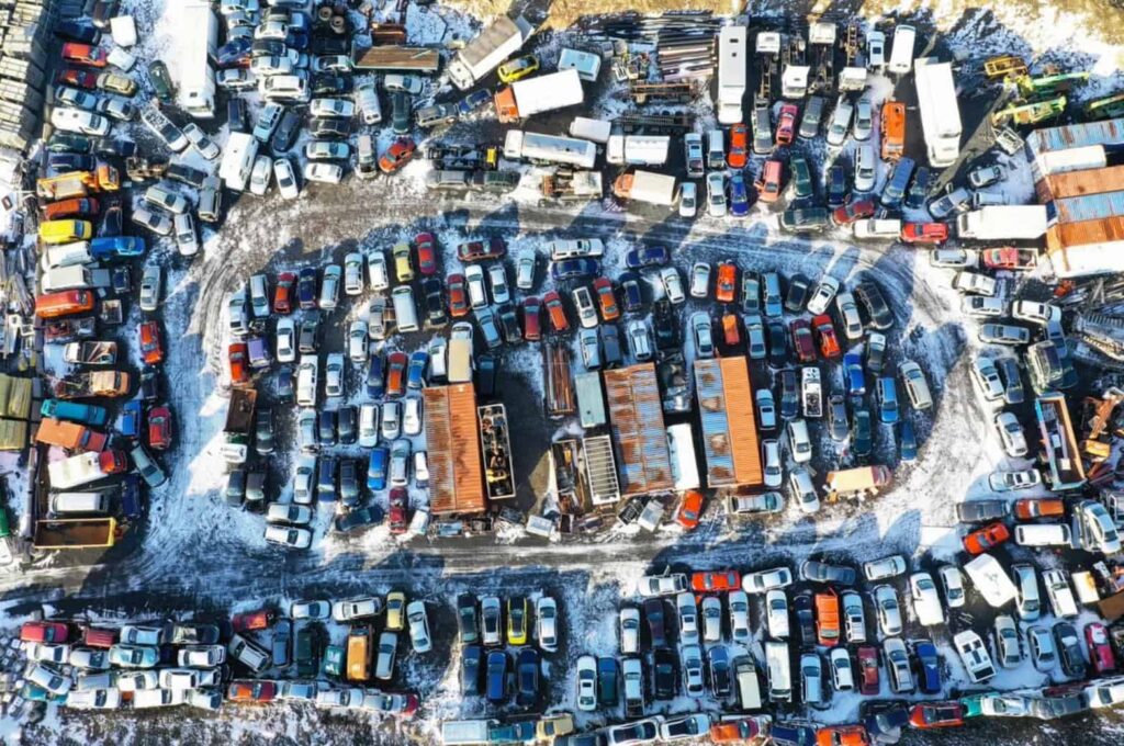 Aerial view of a junk yard filled with junk cars.